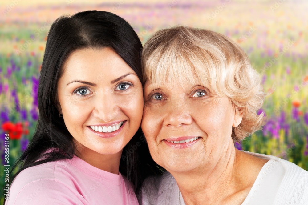 Adult woman with her senior mother in park