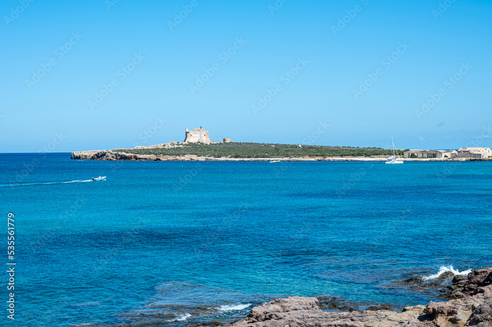 The island of Capo Passero in front of Portopalo where the waters of the two seas divide, the Ionian Sea and the Mediterranean Sea