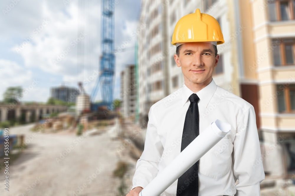Young male builder working with construction cite background Young male builder working with construction cite background