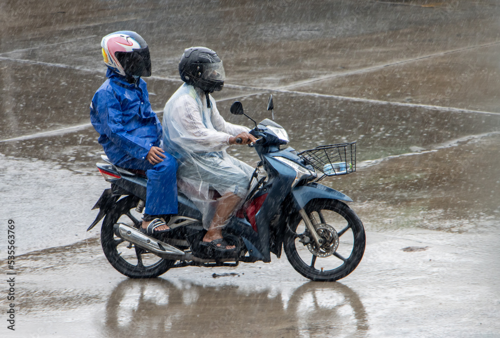 Mototaxi is driving with a passenger in heavy rain