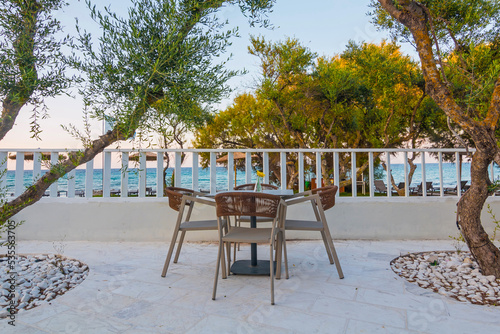 Tables in restaurant on the terrace . Zakynthos, Greece. Superb summer mood, outdoor restaurant. Romantic vibes, summer colors under blue sky