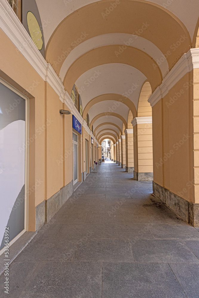 Picture along an old archway with pastel-coloured stone columns