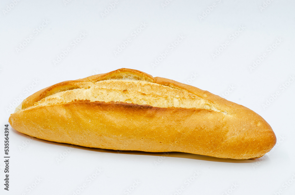 Hot bread out of the oven. Loaf of bread on a white isolated background. The staple food is bread.
