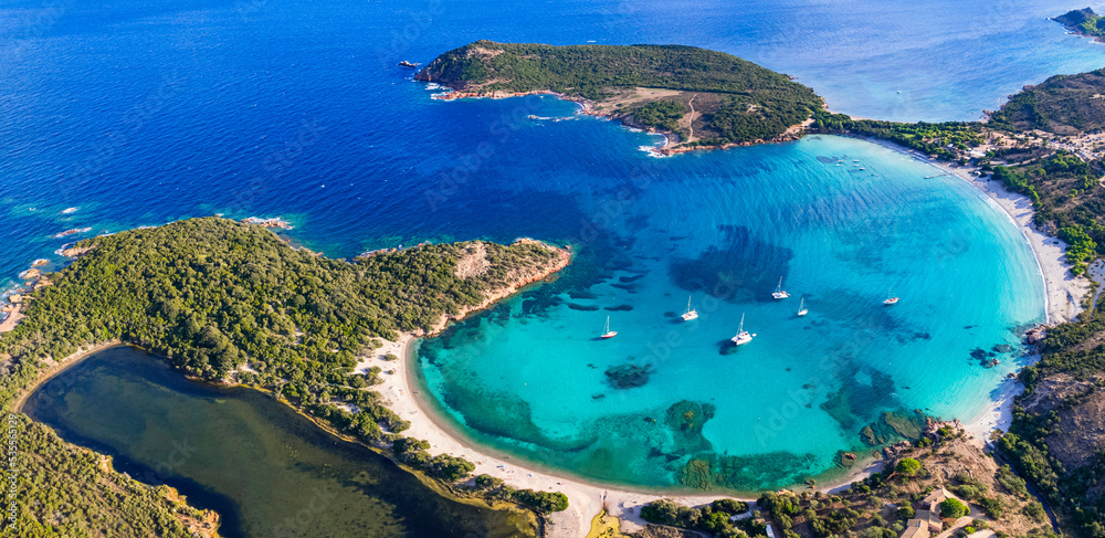 Best beaches of Corsica island - aerial panoramic view of beautiful Rondinara beach with perfect round shape and crystal turquoise sea.
