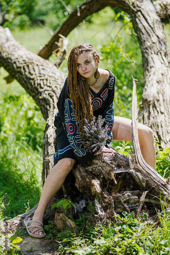 Beautiful girl with dreadlocks, dressed hippie style,poses outdoors. Beautiful girl with dreadlocks, dressed hippie style,poses outdoors.