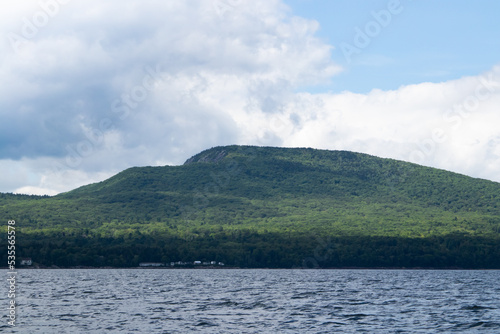 Mountain meets the sea with sky and clouds