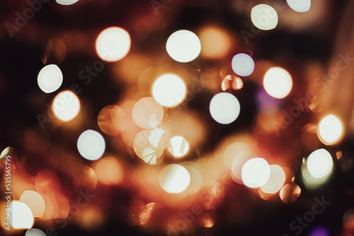 Bright colored defocus lights. Festive Christmas background. Multi-colored bokeh, blurry backdrop.