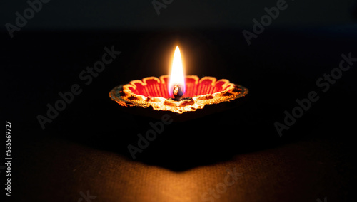 Diwali, Deepavali Hindu festival of lights. Diya lamp lit on black, close up