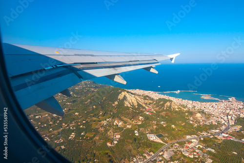 Airplane flying above the Zakynthos, Greece. Sunny day