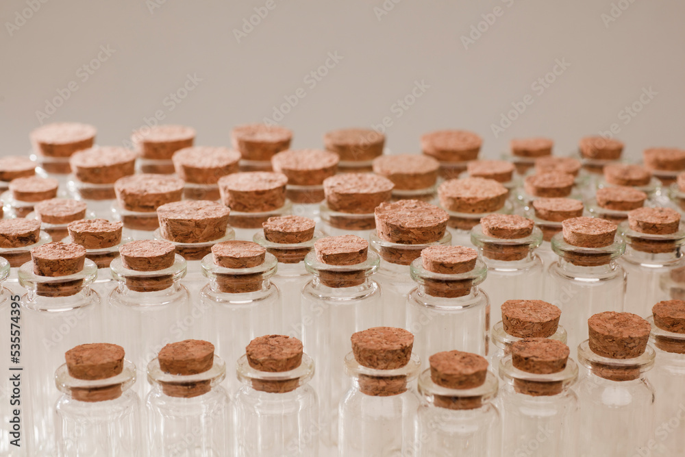 glass jars with corks, soft green background glass jars with corks, soft green background
