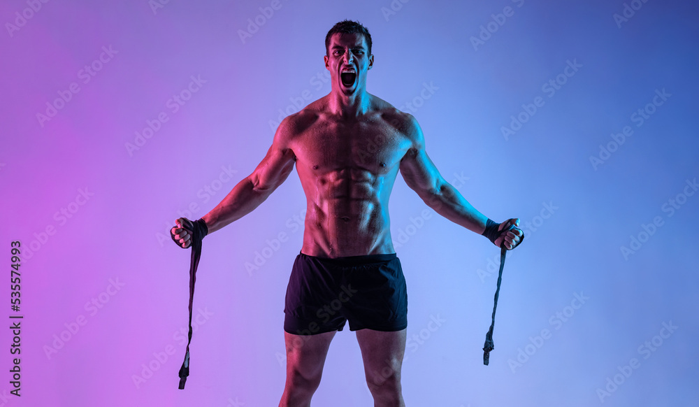 Boxing concept. Sportsman muay thai boxer fighting in gloves. Isolated on neon background. Copy Space. Boxing concept. Sportsman muay thai boxer fighting in gloves. Isolated on neon background. Copy Space.