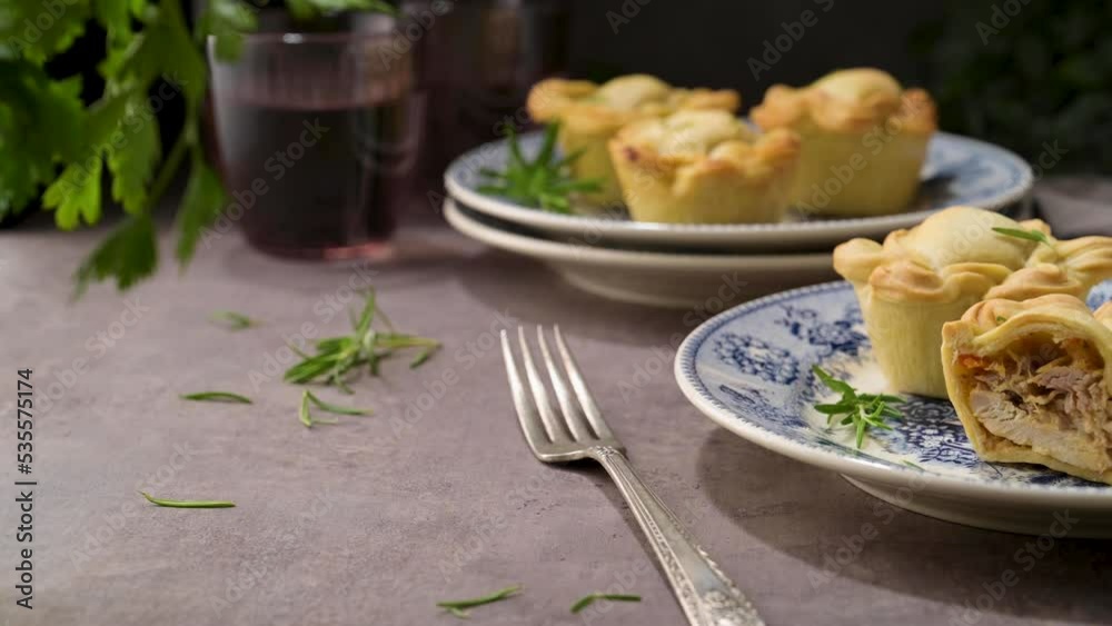 Typical portuguese snack with meat. Chicken pies know as empadas de frango or galinha on old fashioned ceramic plates. Typical portuguese snack with meat. Chicken pies know as empadas de frango or galinha on old fashioned ceramic plates.