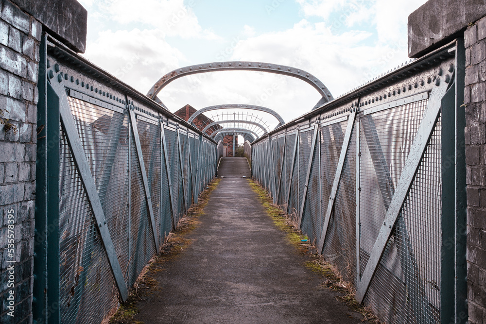 old iron footbridge over railway lines