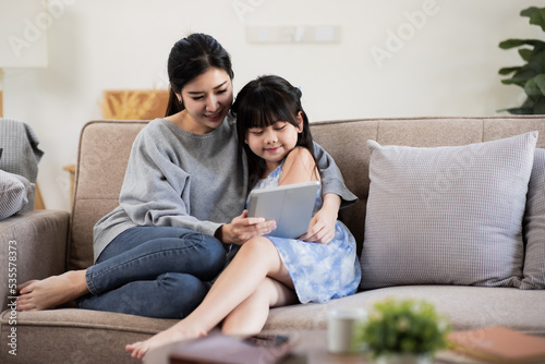 Happy mother and child having fun in living room at home, happy family holiday concept. 