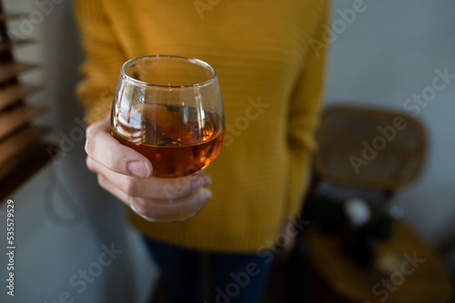 a glass of whiskey on hand  liquid   