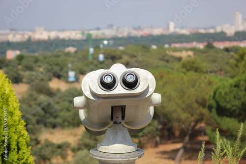 Fixed binoculars of Parque del Oeste in Madrid, Spain with the cityscape in the background photo