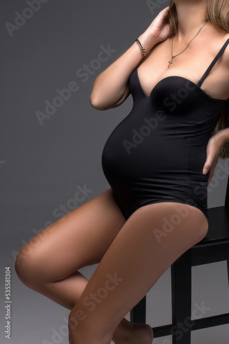 pregnant woman in black lingerie close up © Tatsiana