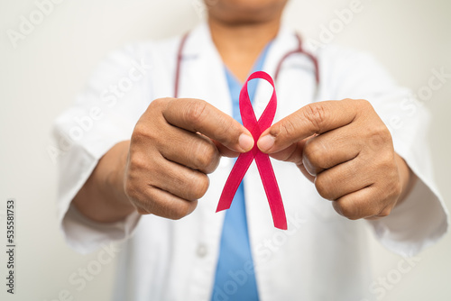 Breast cancer, Asian doctor woman with pink ribbon, symbol of World Breast Cancer Day.