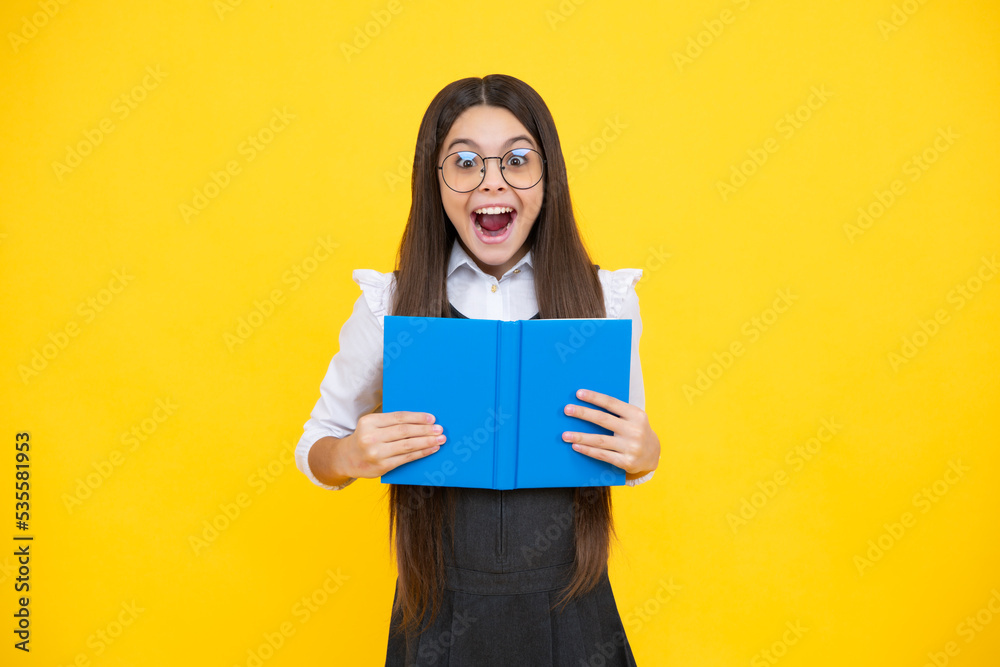 Schoolgirl with copy book posing on isolated background. Literature lesson, grammar school. Intellectual child reader. Excited face, cheerful emotions of teenager girl. Schoolgirl with copy book posing on isolated background. Literature lesson, grammar school. Intellectual child reader. Excited face, cheerful emotions of teenager girl.