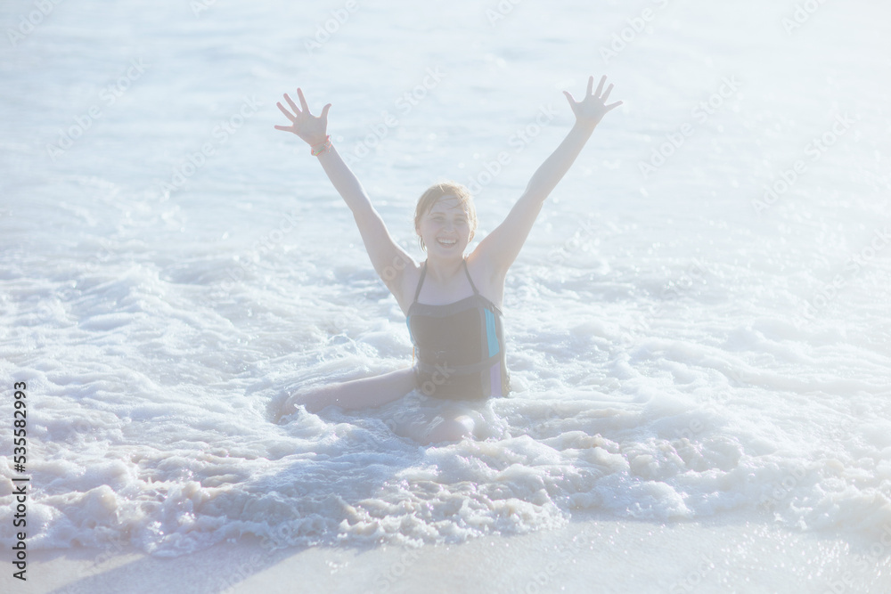 Naklejka premium happy modern teen at beach in beachwear rejoicing