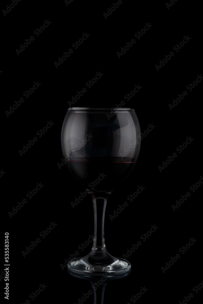 glasses of red wine on a black background with reflection glasses of red wine on a black background with reflection