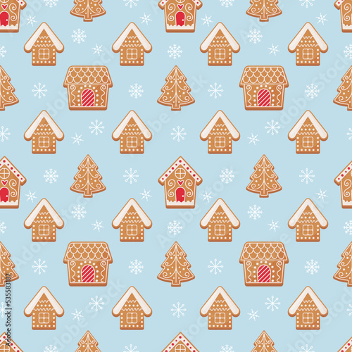 Christmas gingerbread seamless pattern. Gingerbread trees and houses on a blue snowy background.