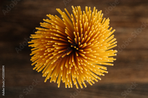 
Spaghetti on wooden background top view