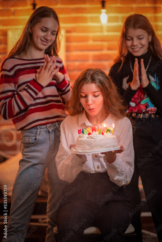 Girlfriends celebrate birthday in a cafe and have fun. Girlfriends celebrate birthday in a cafe and have fun.