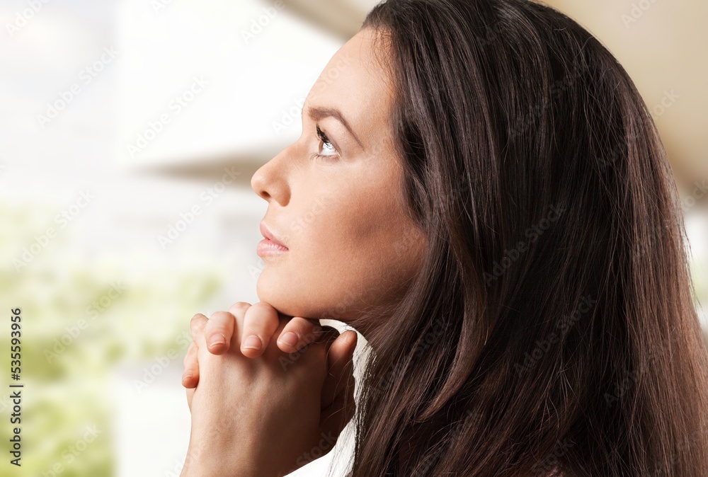 Hopeful young woman pray at home, Christian concept