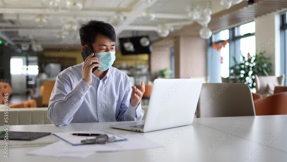 young businessman works with laptop in office