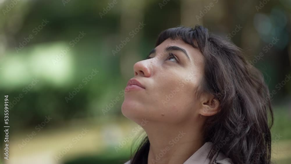 Contemplative young woman looking at sky. Person closing eyes in meditation. Girl opens eye to sky having HOPE and FAITH Contemplative young woman looking at sky. Person closing eyes in meditation. Girl opens eye to sky having HOPE and FAITH
