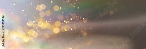 Abstract holographic background with golden sparklees and bokeh. Festive banner backdrop