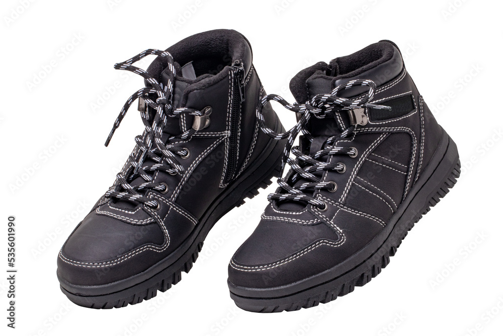 Winter boots. Close-up of a pair elegant black leather winter boots with laces and rivets isolated on white. Clipping path. Macro. Autumn shoe fashion for child boy. Winter boots. Close-up of a pair elegant black leather winter boots with laces and rivets isolated on white. Clipping path. Macro. Autumn shoe fashion for child boy.
