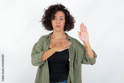 Konstfotografi young beautiful woman with curly short hair wearing green overshirt over white w