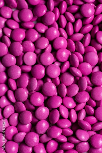 Pink candy coated chocolate button sprinkle texture - M Ms  Smarties  sprinkles