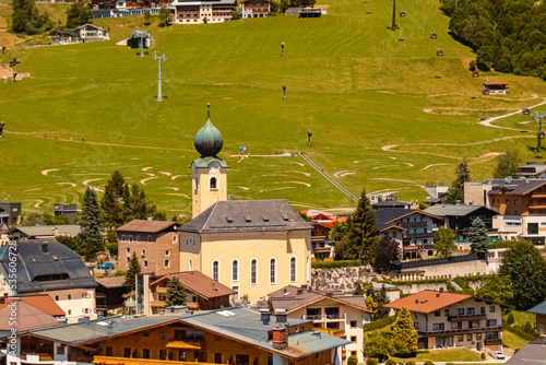 Beautiful aerial view with a church on a sunny summer day at Schattberg, Saalbach-Hinterglemm, Salzburg, Austria photo