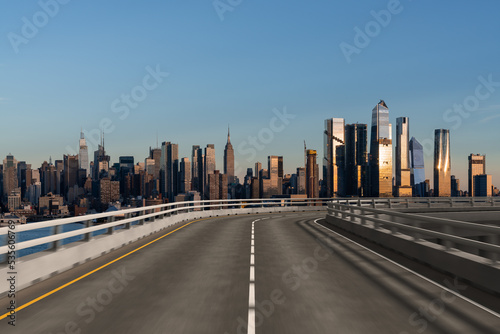 Empty urban asphalt road exterior with city buildings background. New modern highway concrete construction. Concept of way to success. Transportation logistic industry fast delivery. New York. USA. © VideoFlow