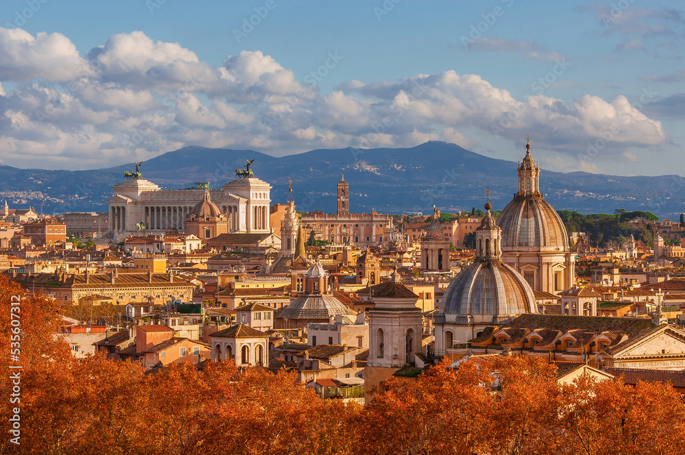 Autumn in Rome. View of the Eternal City historical center old skyline with autumnal red leaves