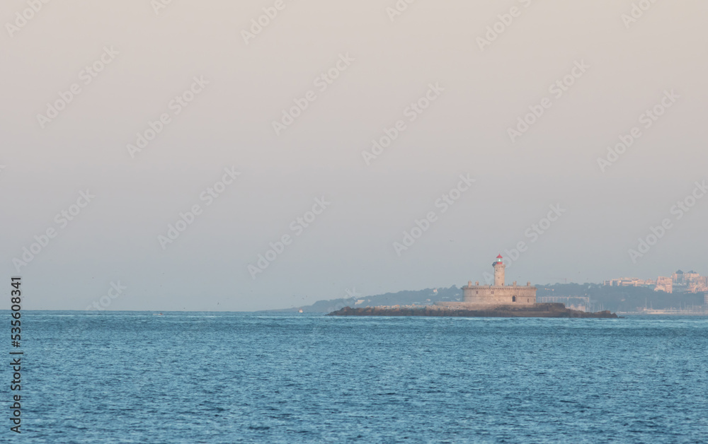 lighthouse at sunrise - coast of Portugal, island on the ocean