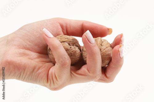 Walnuts in a girl's hand on a white background. Close-up