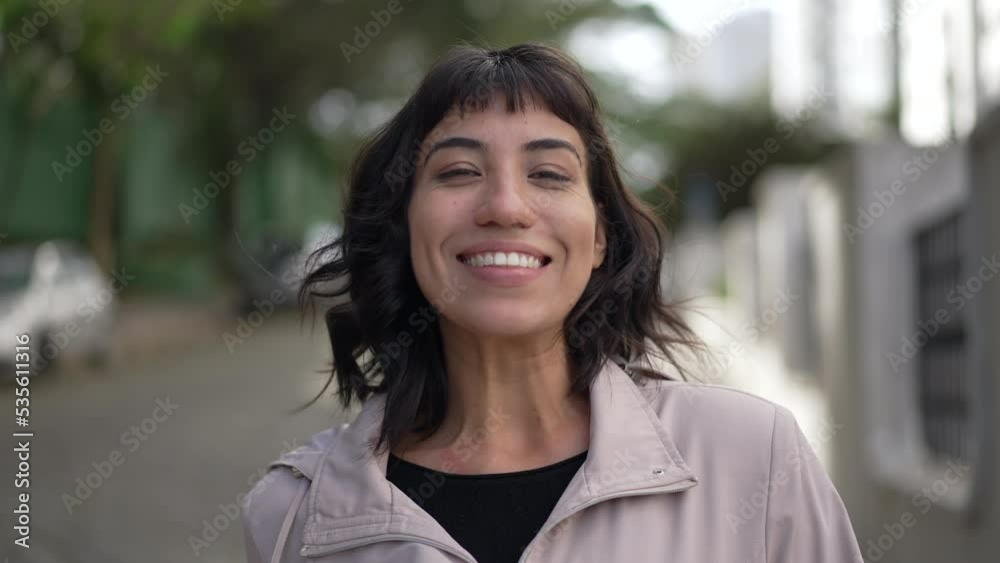 Happy person walking forward toward camera. A smiling south american hispanic latin girl portrait face looking at camera Happy person walking forward toward camera. A smiling south american hispanic latin girl portrait face looking at camera
