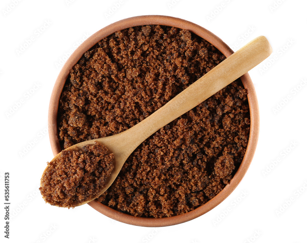Muscovado sugar in clay pot and wooden spoon isolated on white, top view Muscovado sugar in clay pot and wooden spoon isolated on white, top view
