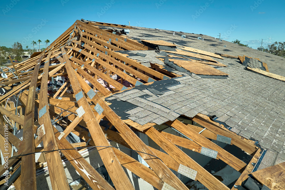 Hurricane Ian destroyed house roof in Florida residential area. Natural ...