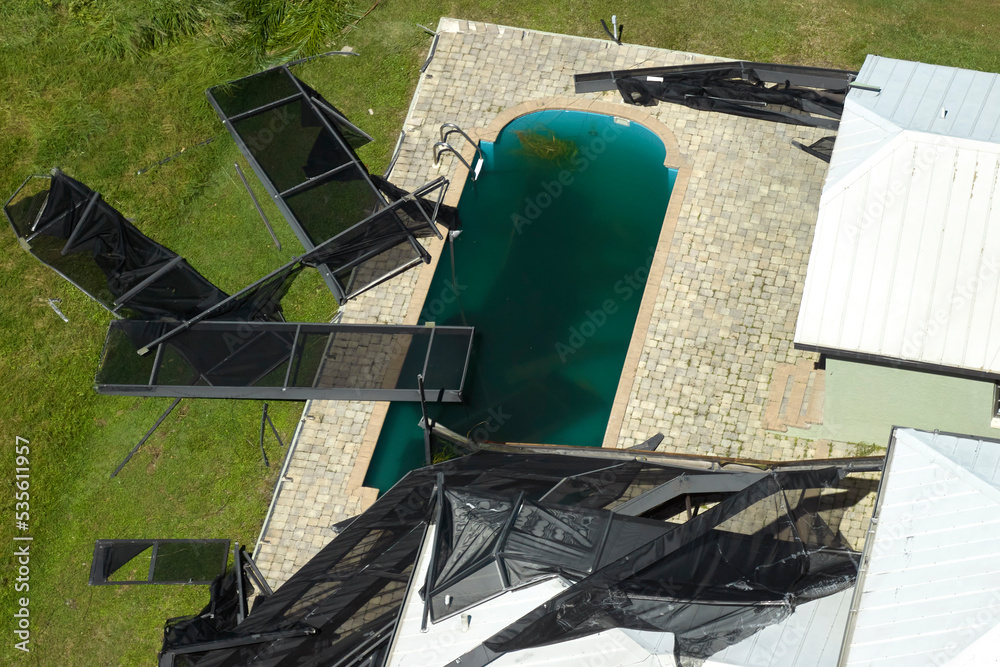 Hurricane Ian destroyed swimming pool lanai enclosure on house yard in ...