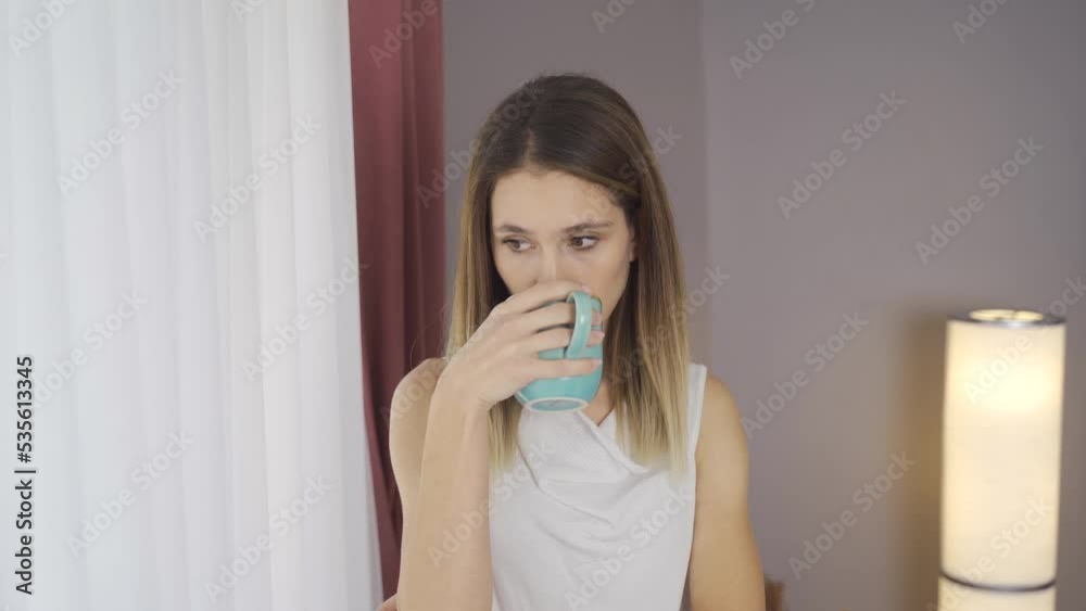 Thoughtful woman by the window at home drinks coffee.
Woman drinking coffee by the window at home, looking outside.
Thoughtful woman by the window at home drinks coffee.
Woman drinking coffee by the window at home, looking outside.