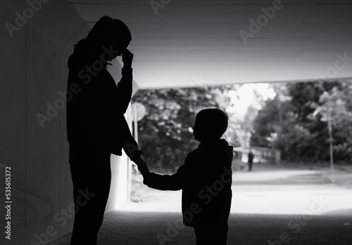 Mother crying next to her child. Family divorce, hardship concept.
