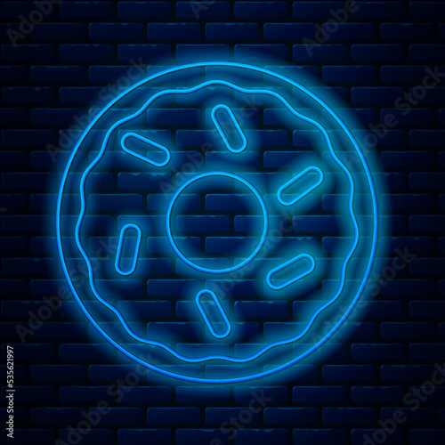 Glowing neon line Donut with sweet glaze icon isolated on brick wall background. Vector