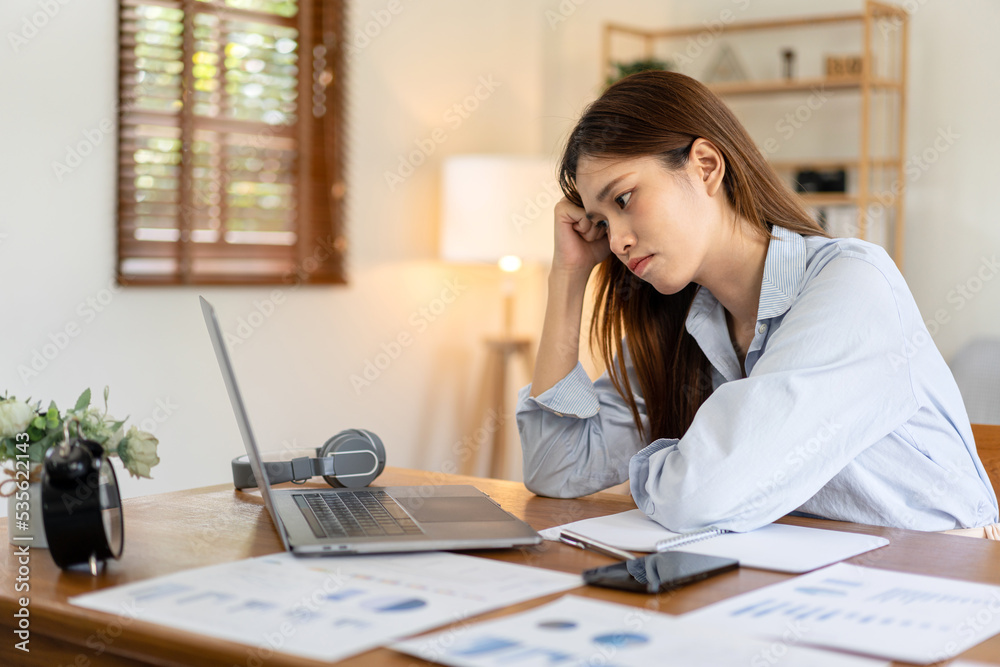 Female freelance is feeling stressful and headache from thinking the strategy plan of the business Female freelance is feeling stressful and headache from thinking the strategy plan of the business