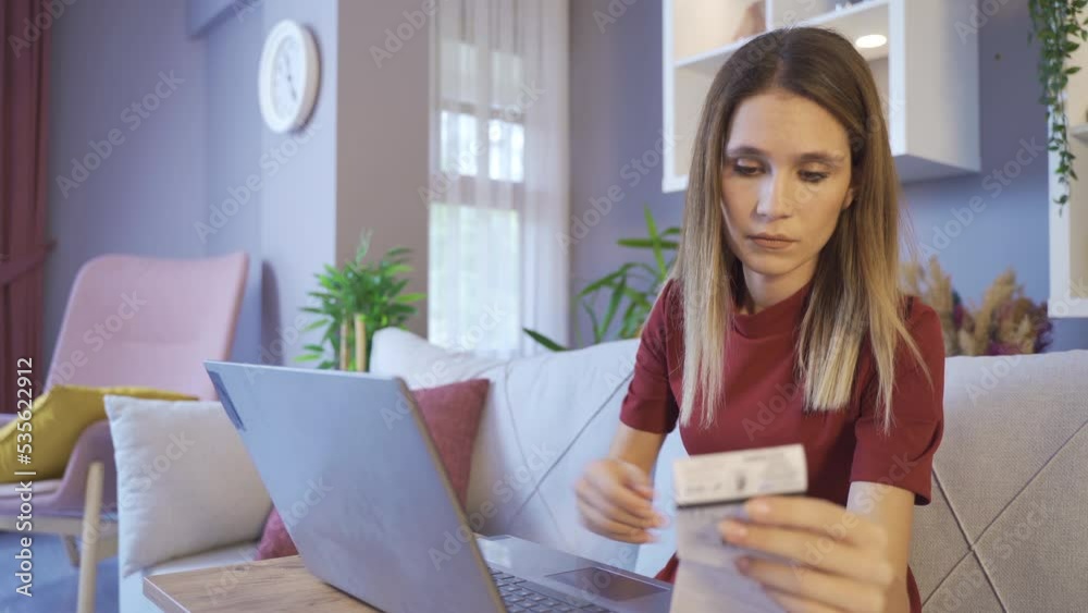 Making a payment online.
Woman paying online with bills at home.
Making a payment online.
Woman paying online with bills at home.