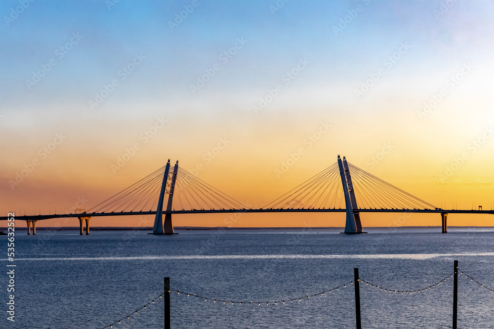 sunset on the background of the bridge and light bulbs garlands sunset on the background of the bridge and light bulbs garlands